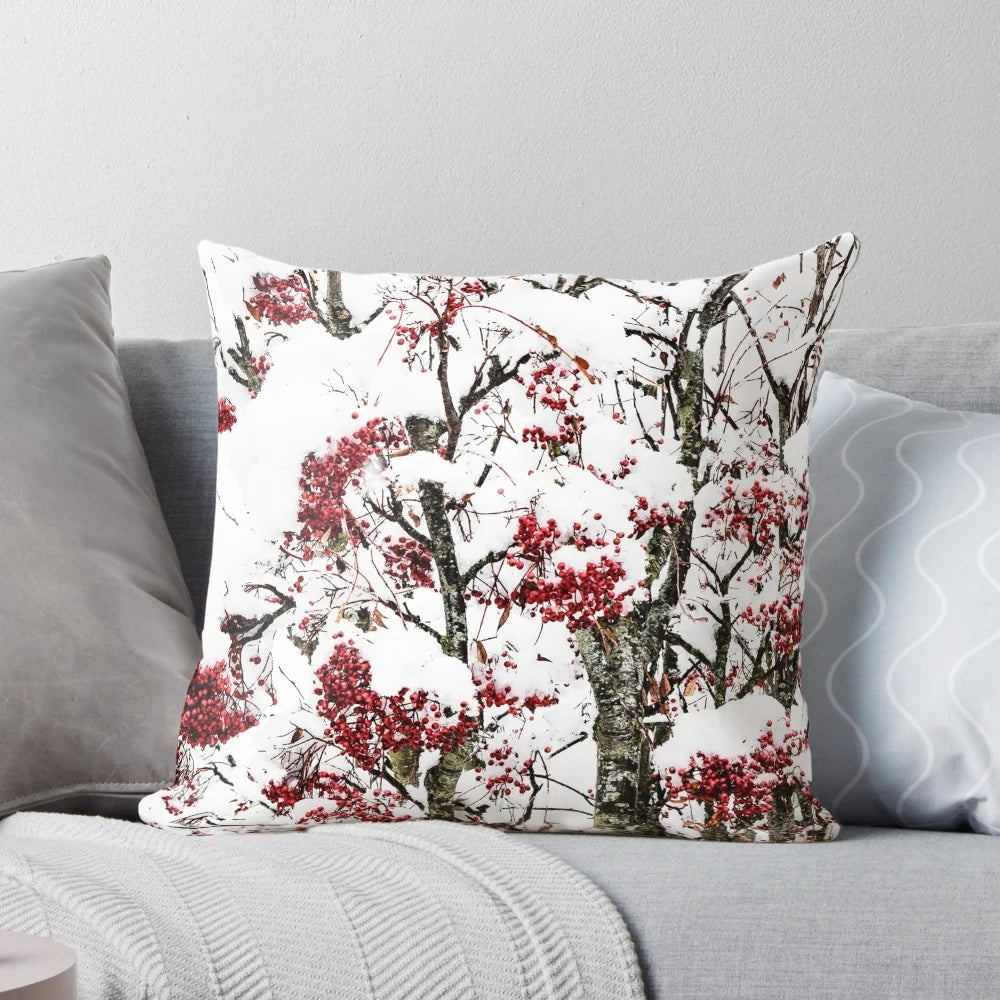 A decorative pillow featuring a minimalist design of snowy berries and branches