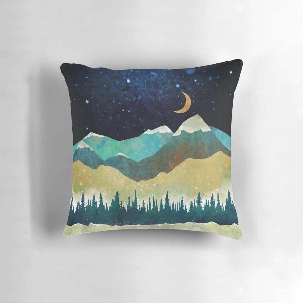 Serene snowy night landscape with blue mountains and trees on a navy blue throw pillow