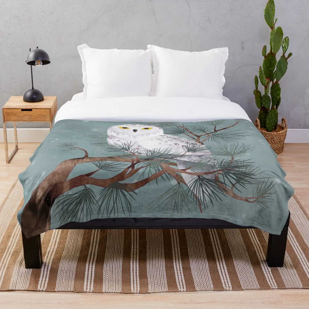 Snowy plush blanket with pine needles and winter scenery