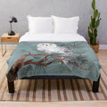 Snowy plush blanket with pine needles and winter scenery