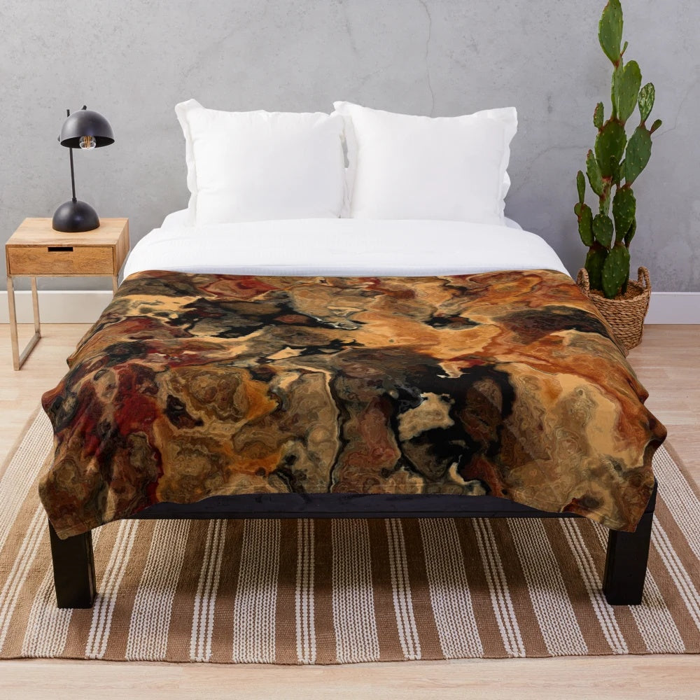 Red, black and rust colored plush blanket with an abstract marble design