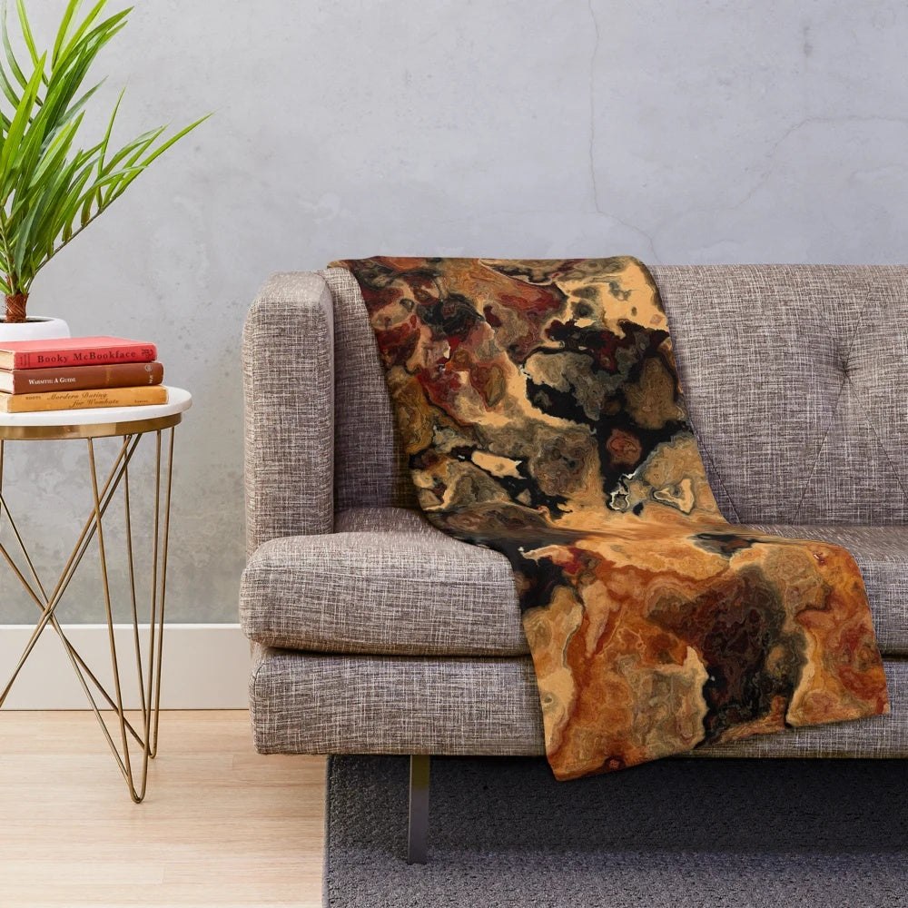 Red, black and rust colored plush blanket with an abstract marble design