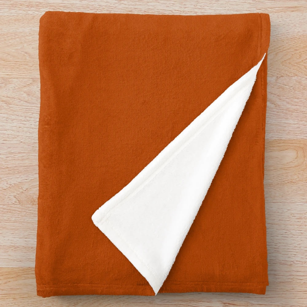 Soft, plush solid color blanket in warm autumn terracotta, orange, and brown hues