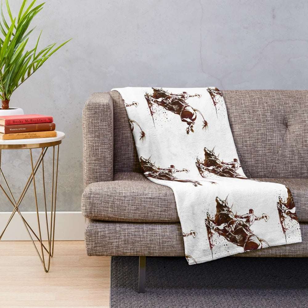 Soft plush blanket featuring a bull riding cowboy in a southwestern style