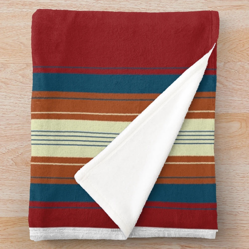 Southwestern-inspired red plush blanket with minimalist lines and tribal patterns