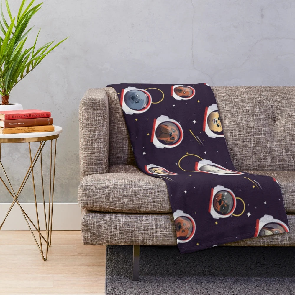 Cute plush blanket featuring space dogs in astronaut suits