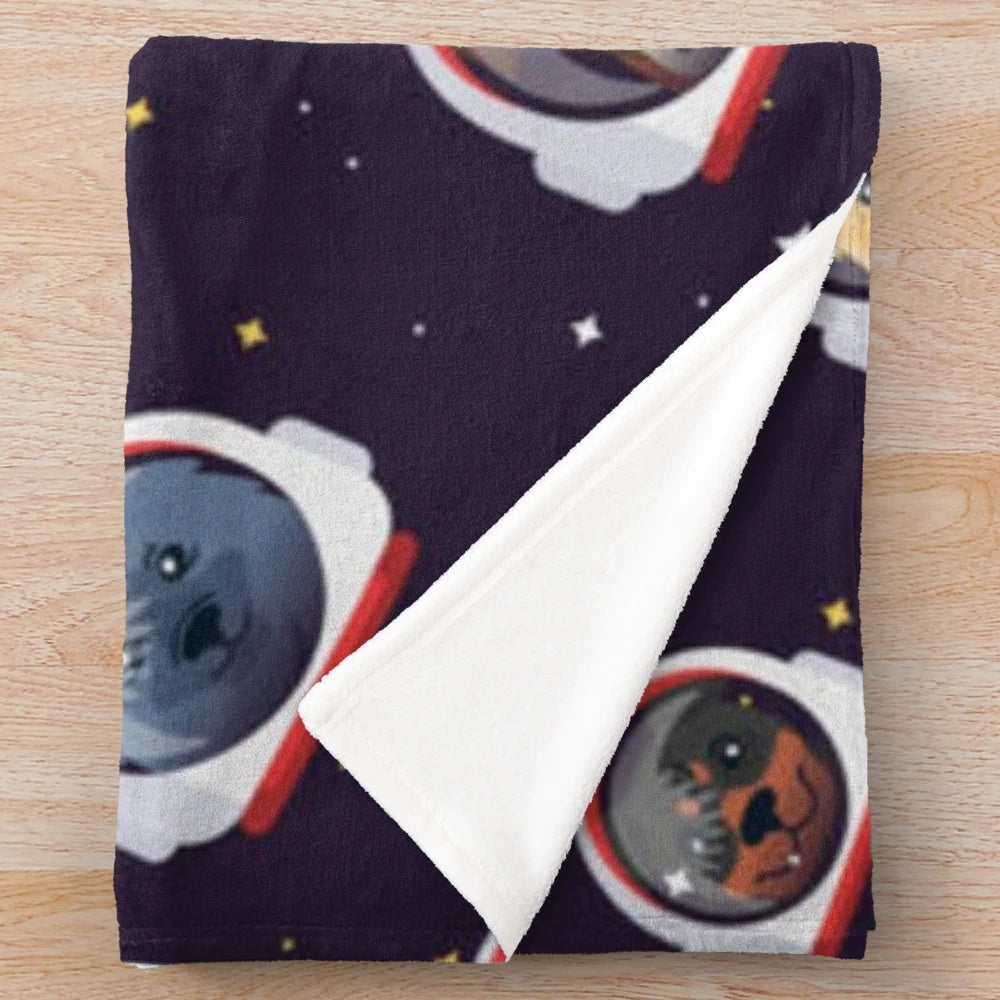 Cute plush blanket featuring space dogs in astronaut suits