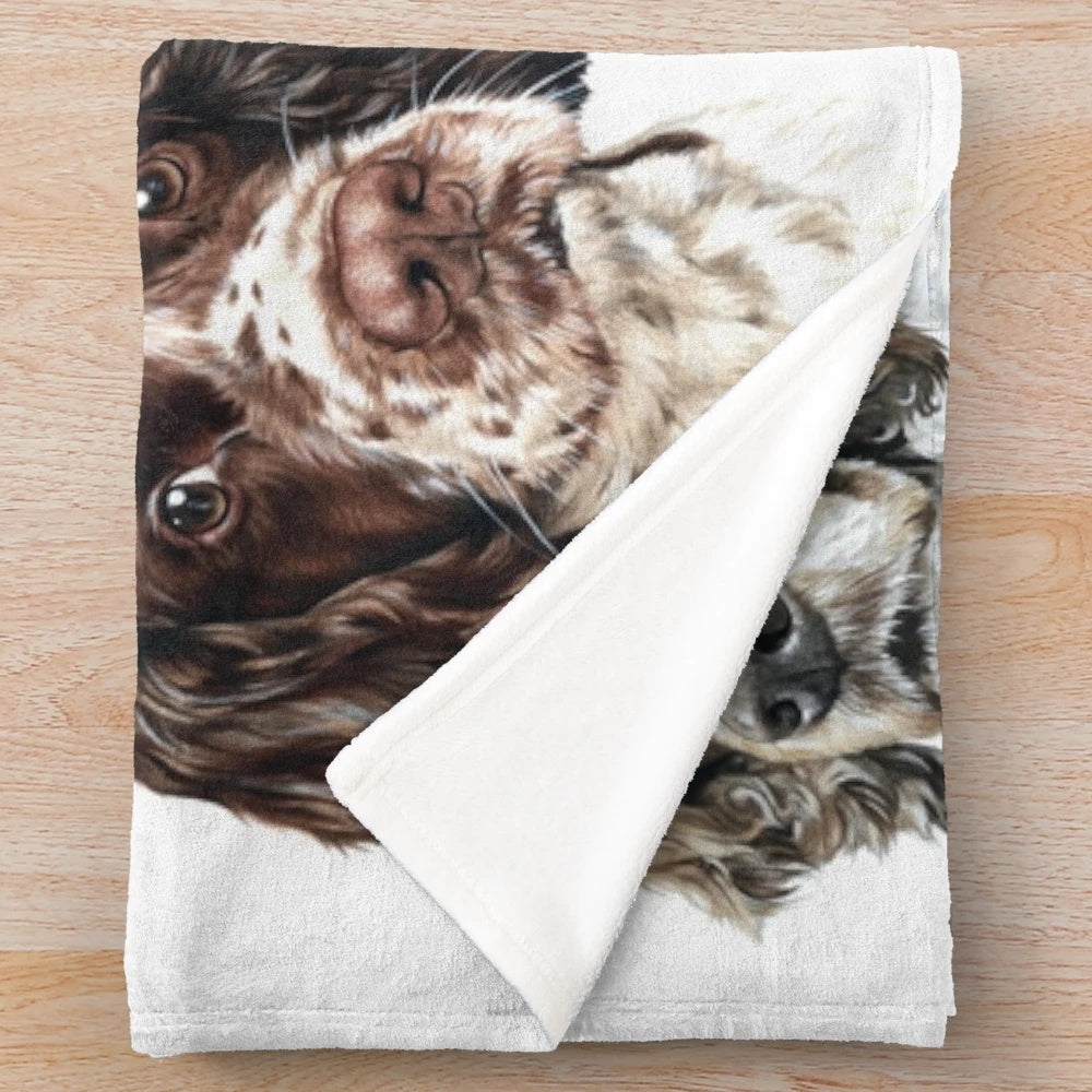 Soft and cuddly plush spaniel blanket featuring a collage of adorable dog images