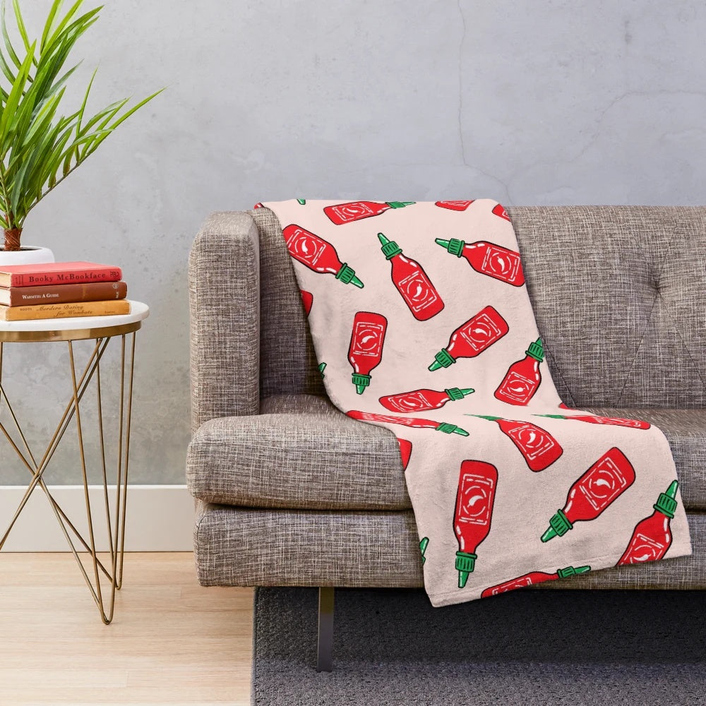 Cozy plush blanket with a spicy sauce and chili pepper design