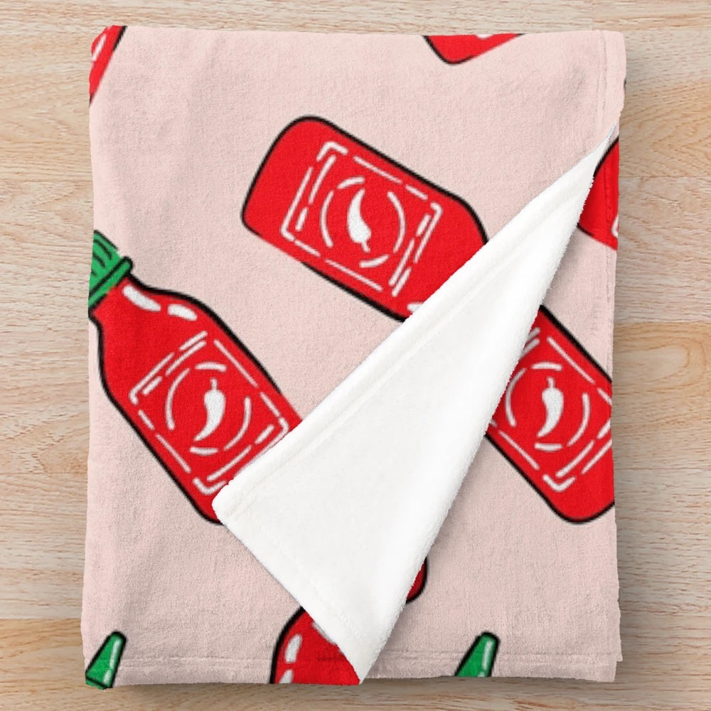 Cozy plush blanket with a spicy sauce and chili pepper design