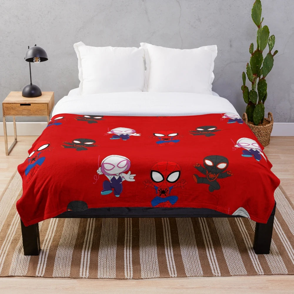 Plush blanket featuring a cartoon spider design in black and white