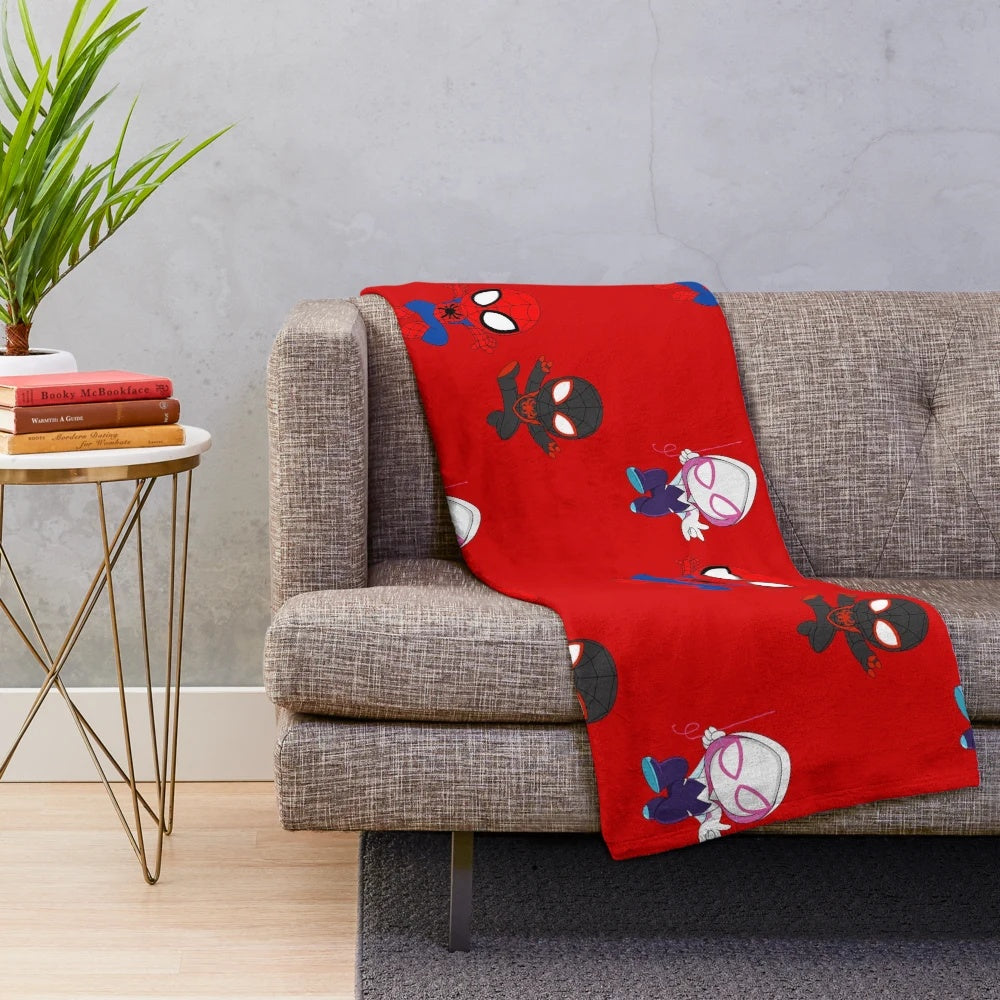 Plush blanket featuring a cartoon spider design in black and white