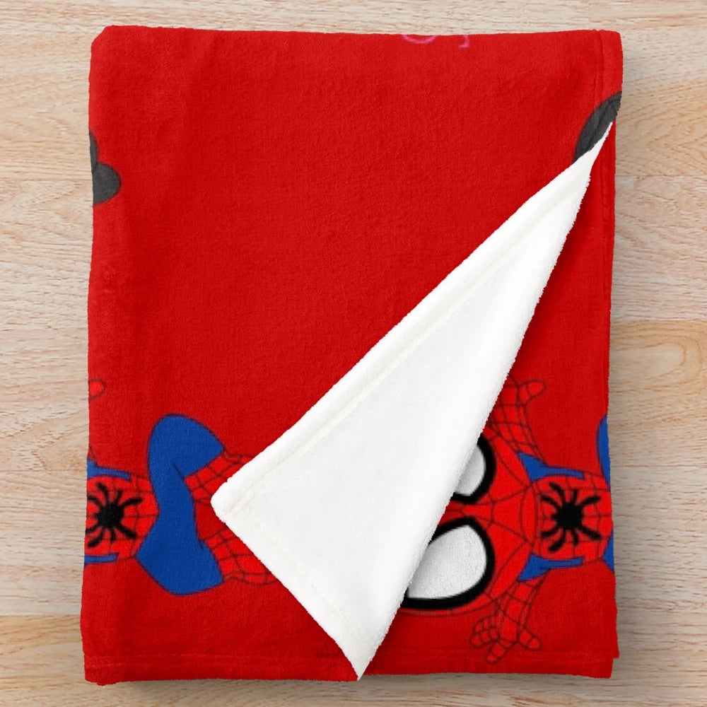 Plush blanket featuring a cartoon spider design in black and white