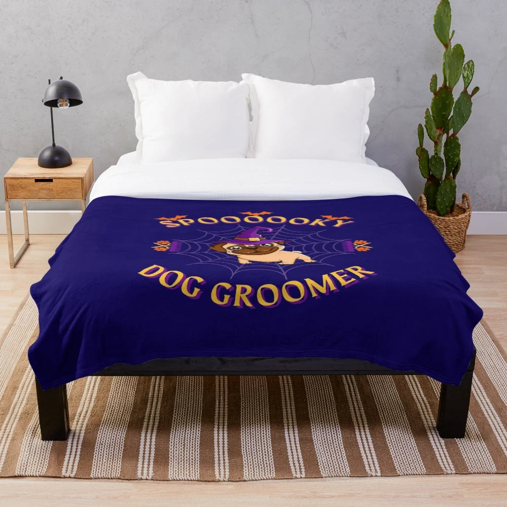 Spooky dog groomer plush blanket with paw prints and pumpkins