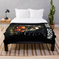 Spooky plush blanket with bats, skulls, and pumpkins for fall and Halloween