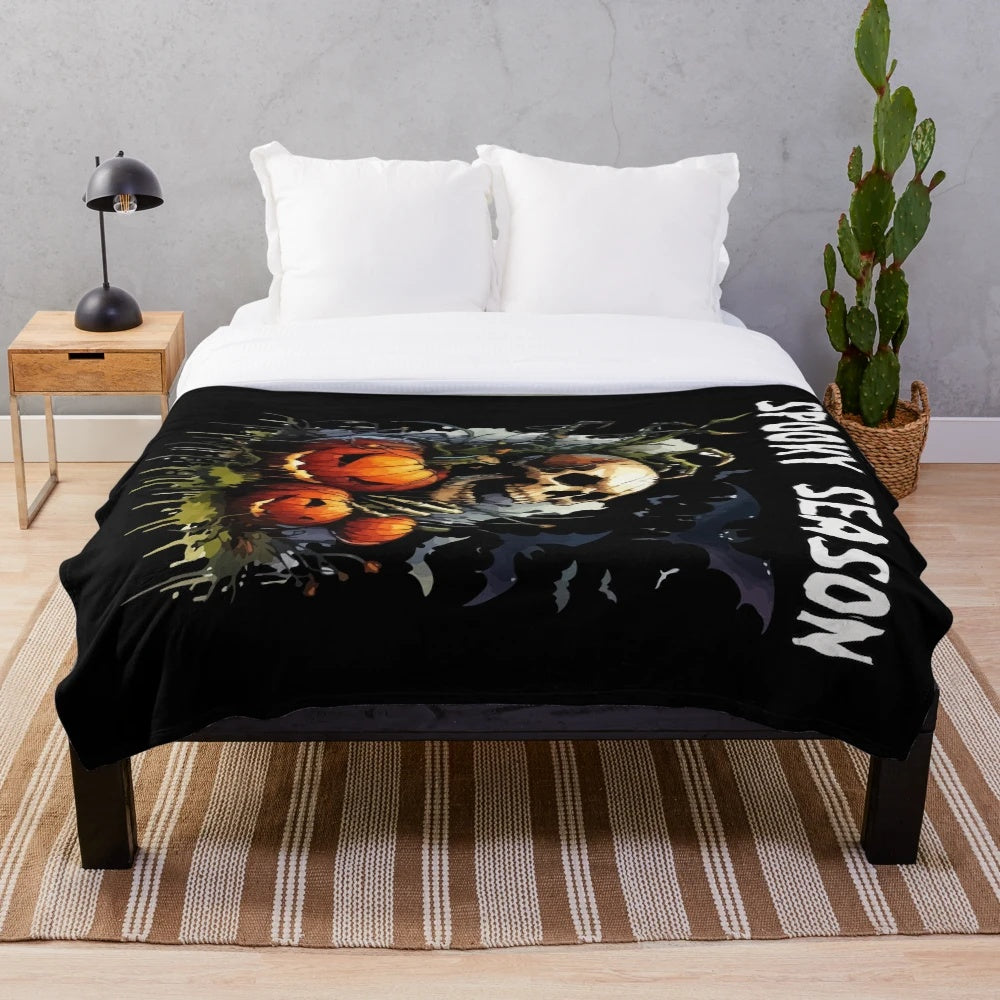 Spooky plush blanket with bats, skulls, and pumpkins for fall and Halloween