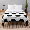 Plush blanket with a soccer ball/football design in black and white hexagon pattern