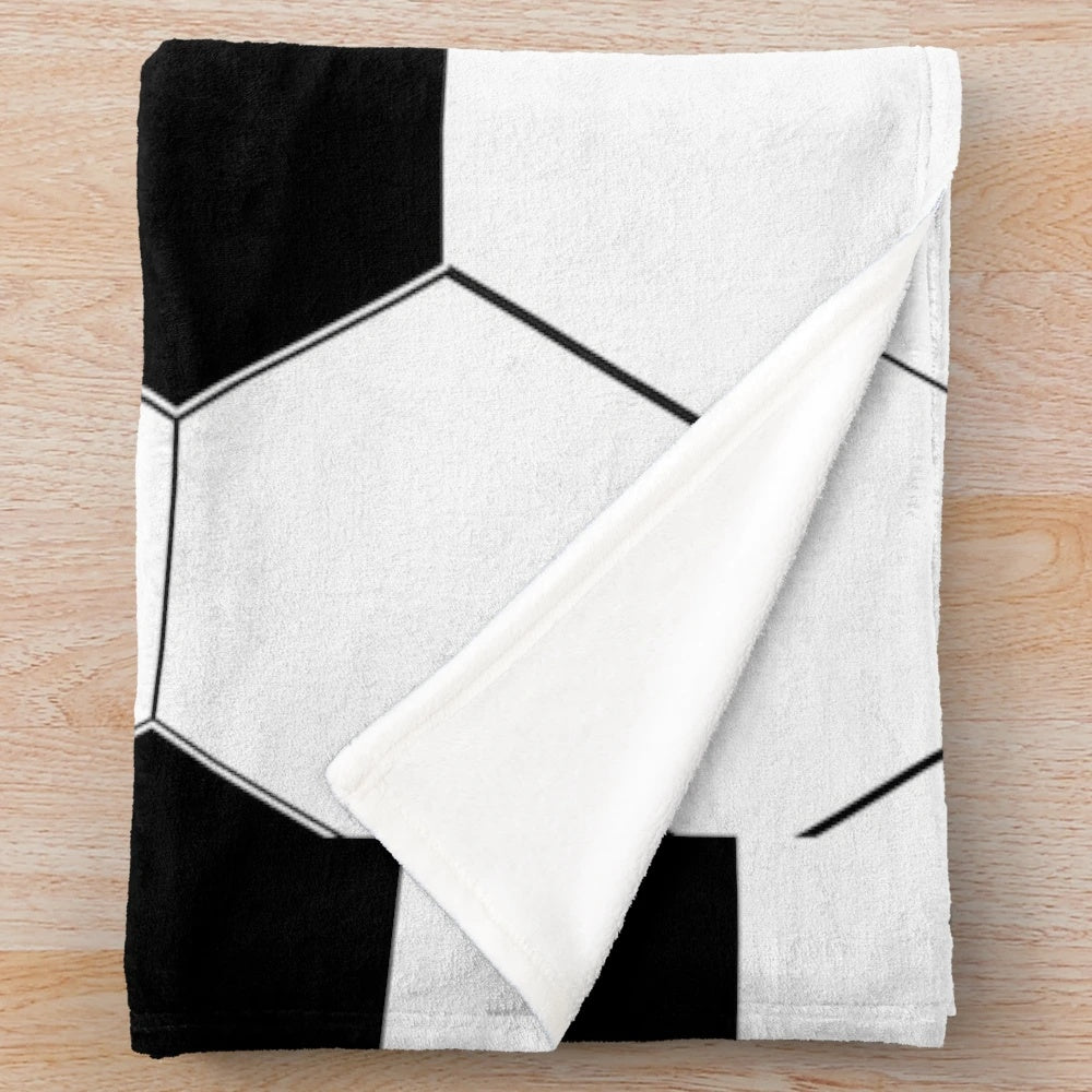 Plush blanket with a soccer ball/football design in black and white hexagon pattern
