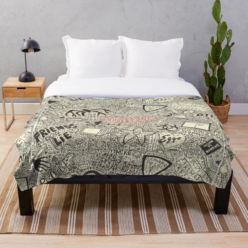 Stranger Things inspired plush blanket with various characters and references