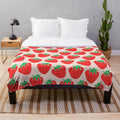 Soft and plush strawberry patterned blanket for a cozy and cute home