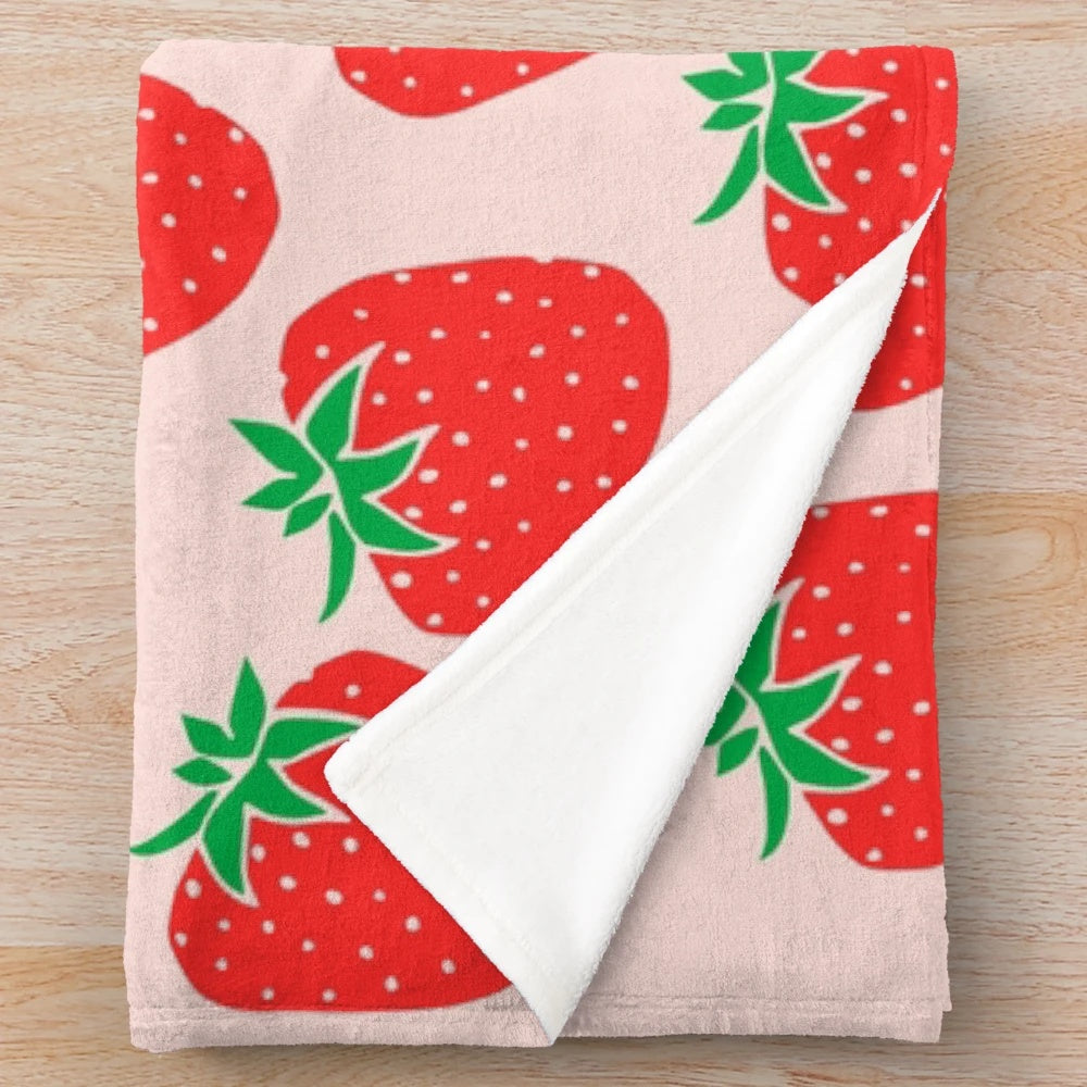 Soft and plush strawberry patterned blanket for a cozy and cute home