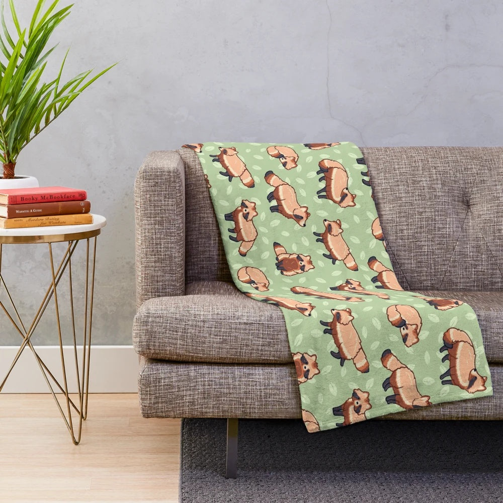 Tanuki patterned plush blanket with a cute cartoon raccoon dog design