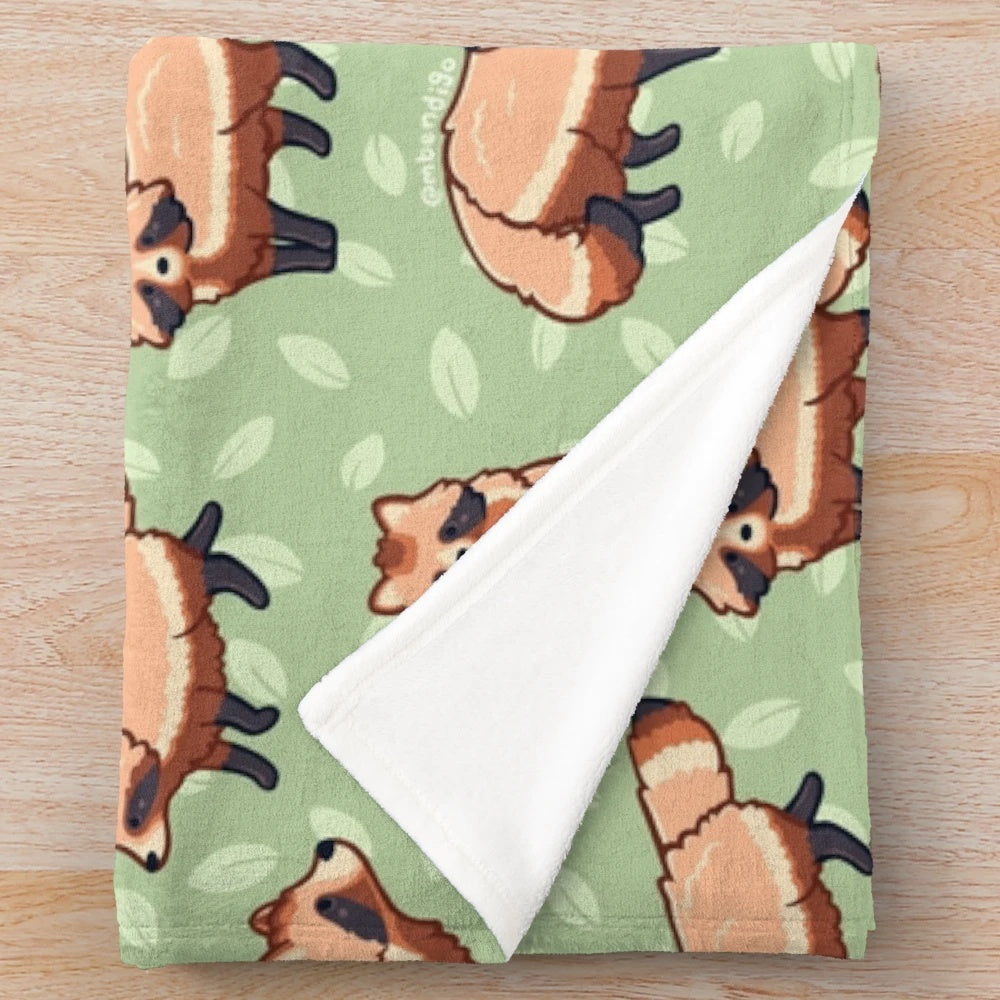 Tanuki patterned plush blanket with a cute cartoon raccoon dog design