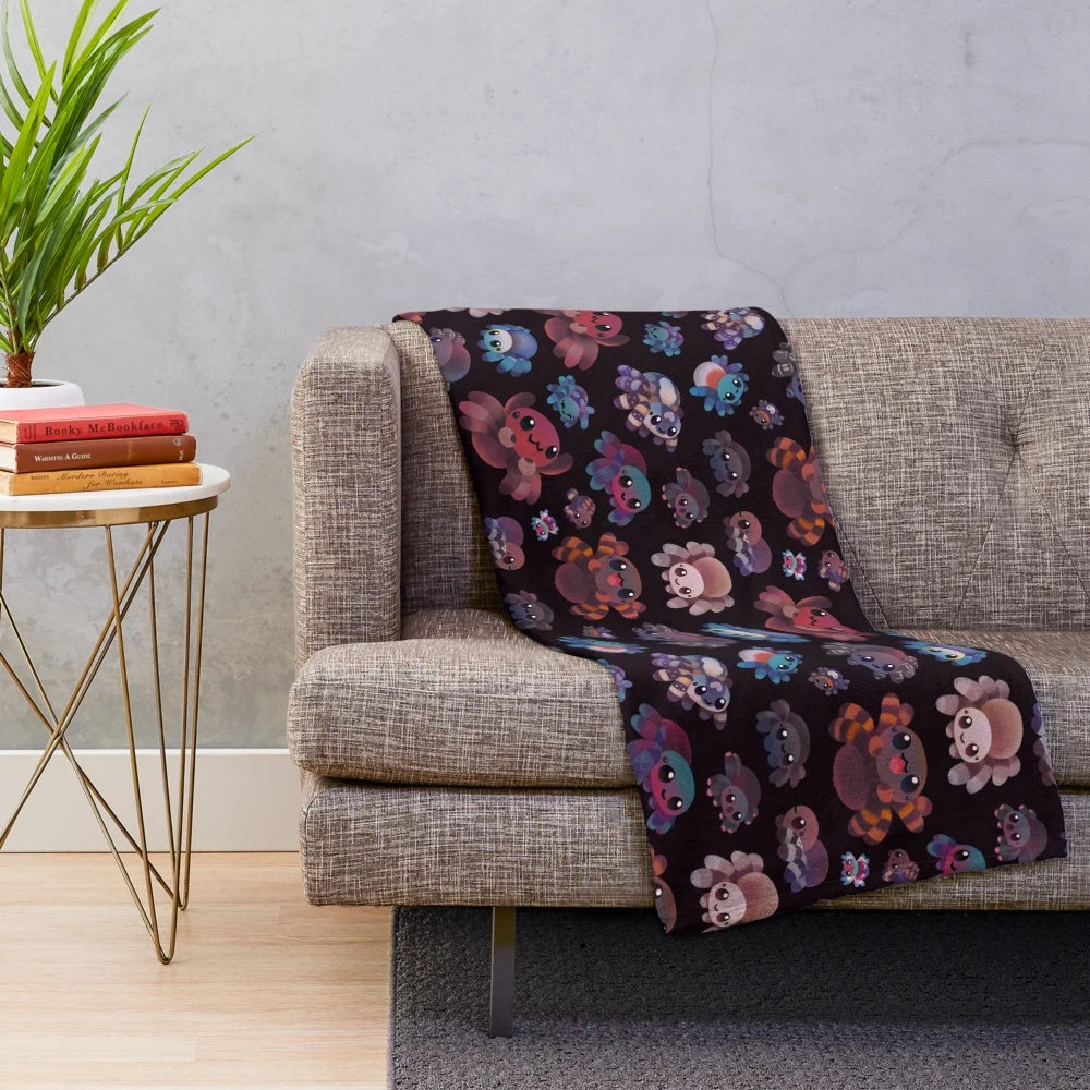 Dark plush blanket featuring a tarantula design