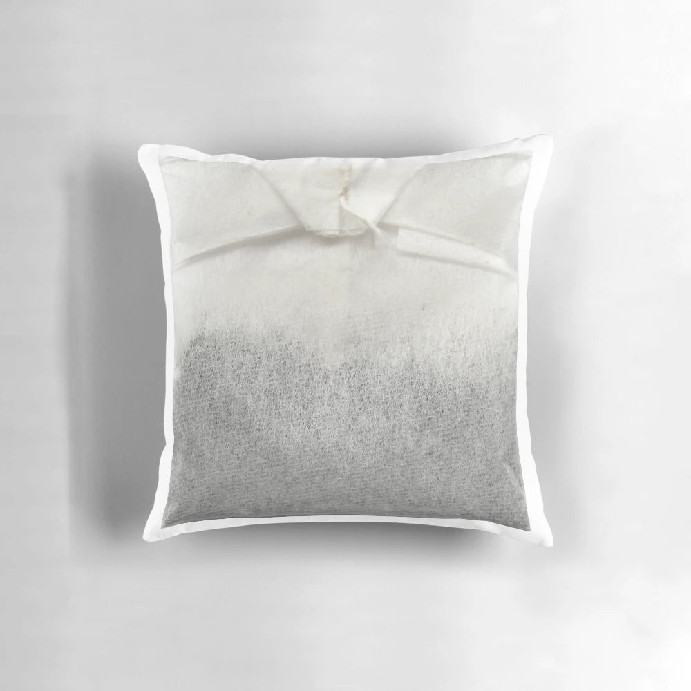 A plush tea bag-shaped pillow with a soothing, natural design