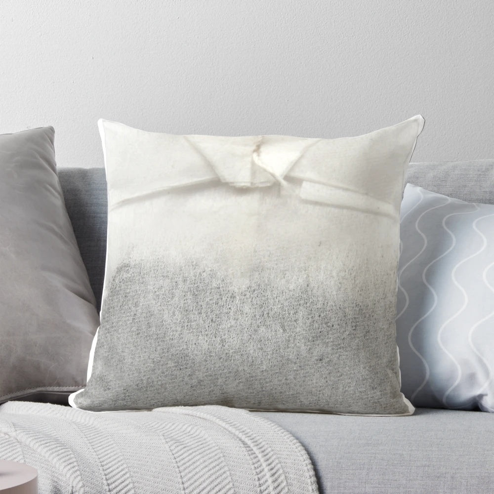 A plush tea bag-shaped pillow with a soothing, natural design