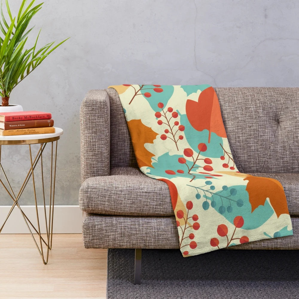 Teal and orange plush blanket with fall foliage design