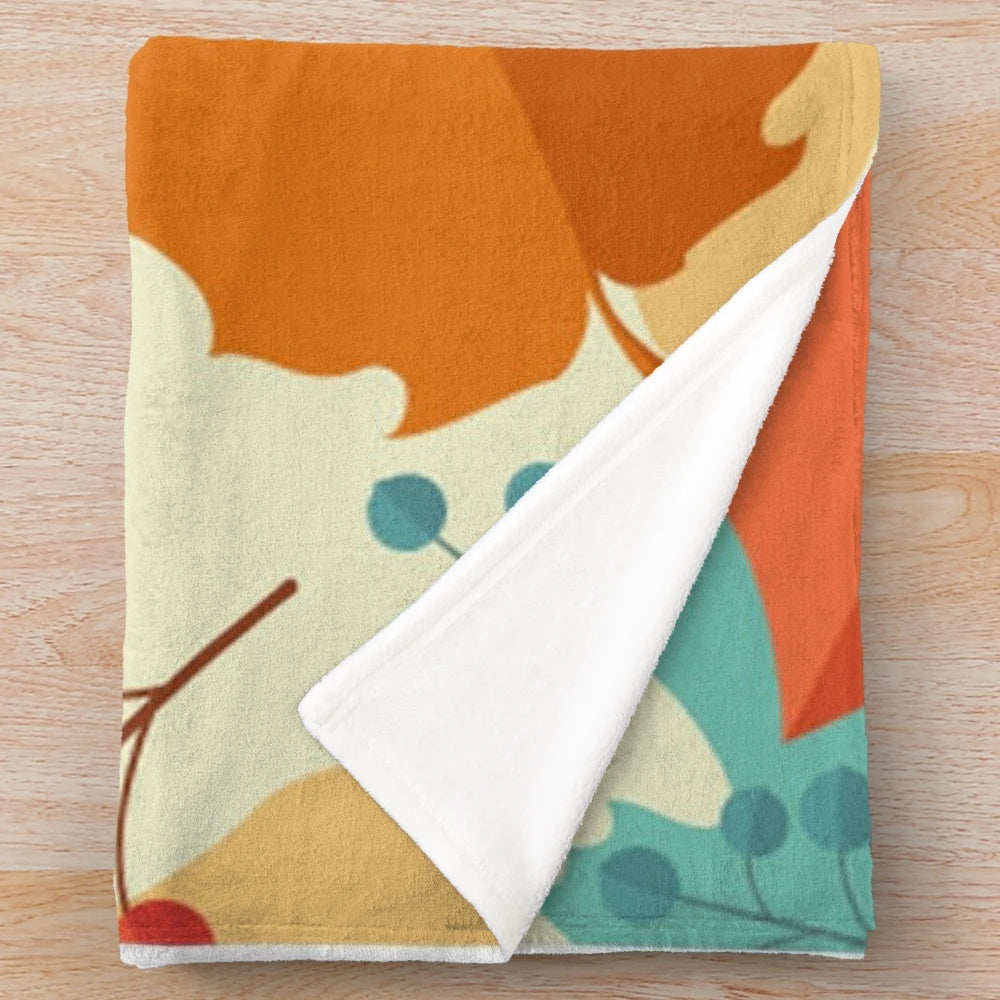 Teal and orange plush blanket with fall foliage design