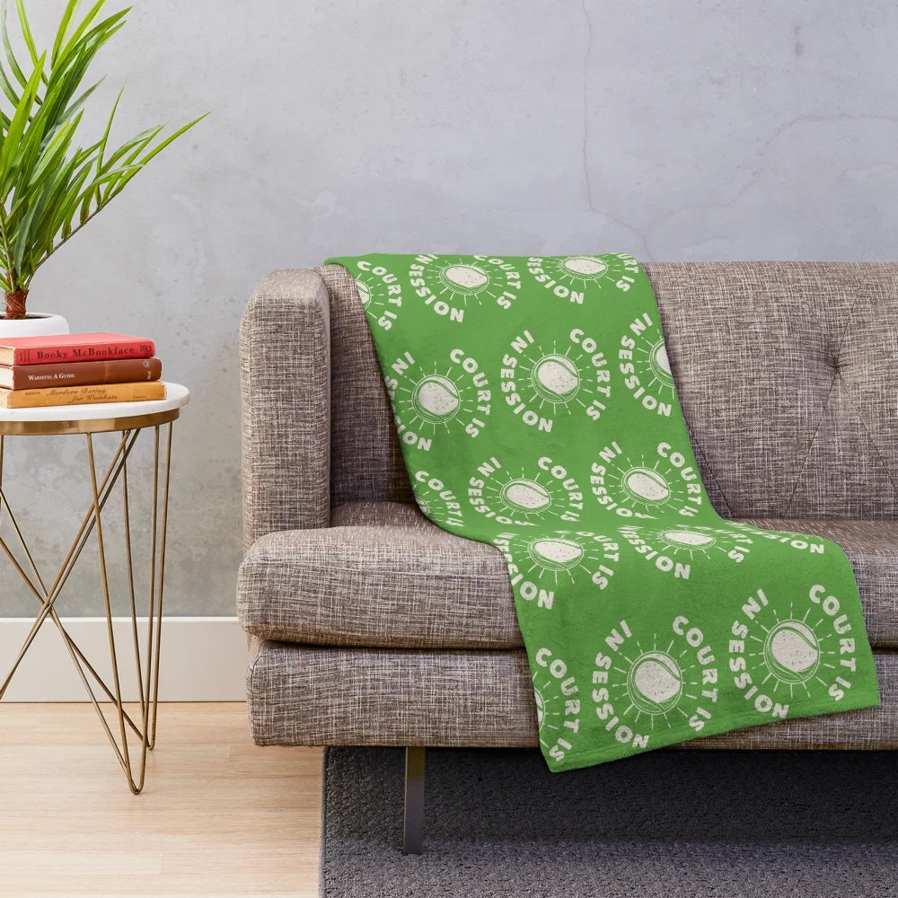 A plush blanket featuring a court session design, perfect for tennis fans and sports enthusiasts.