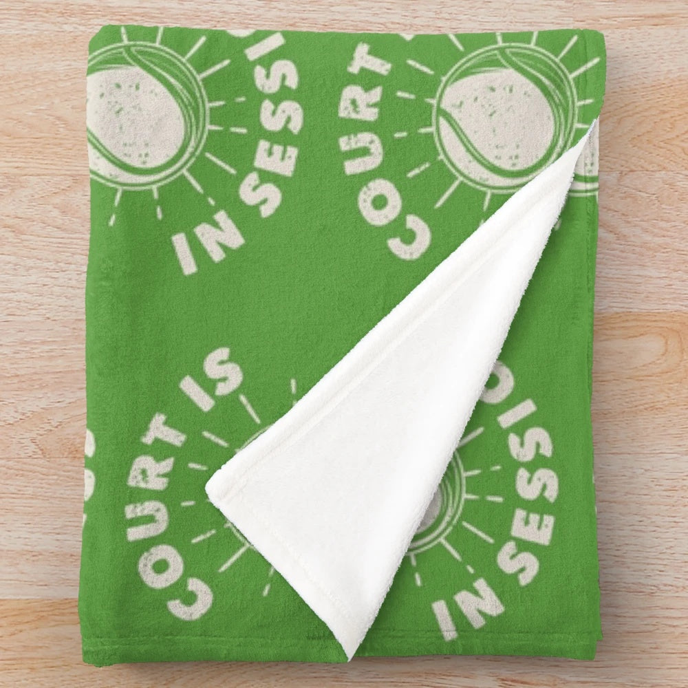 A plush blanket featuring a court session design, perfect for tennis fans and sports enthusiasts.