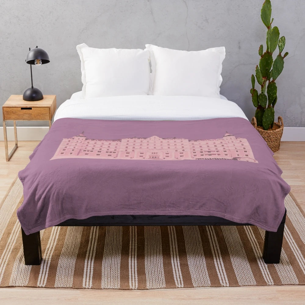 The Grand Budapest Hotel-inspired plush blanket with a pink and pastel color scheme