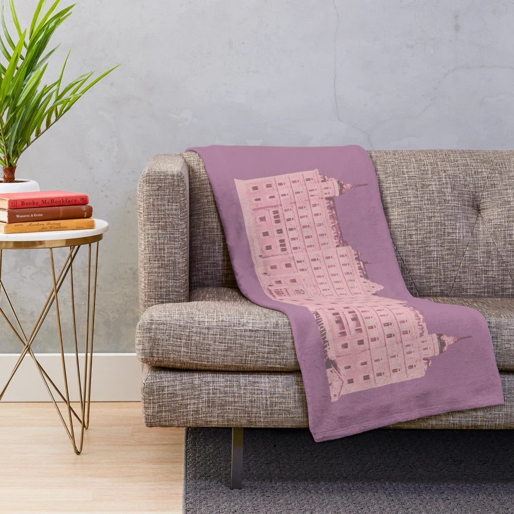The Grand Budapest Hotel-inspired plush blanket with a pink and pastel color scheme