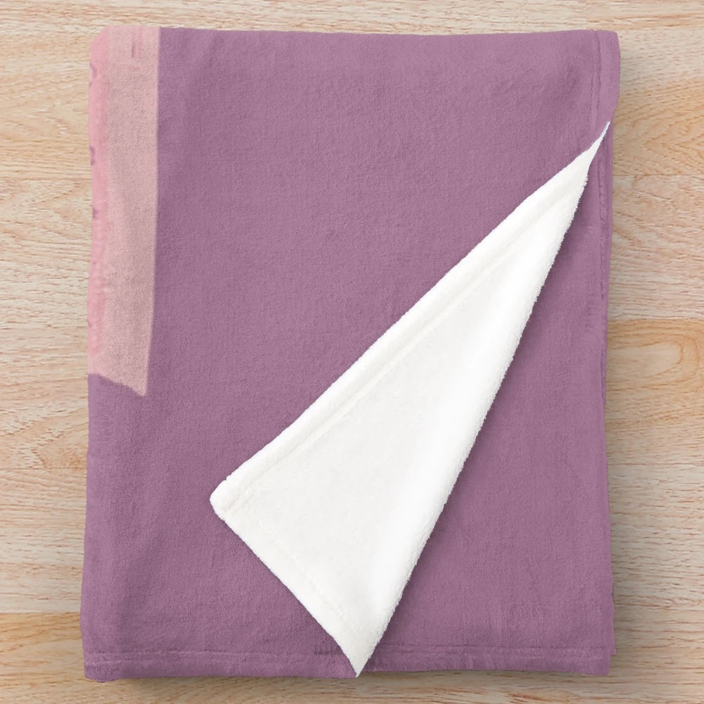 The Grand Budapest Hotel-inspired plush blanket with a pink and pastel color scheme