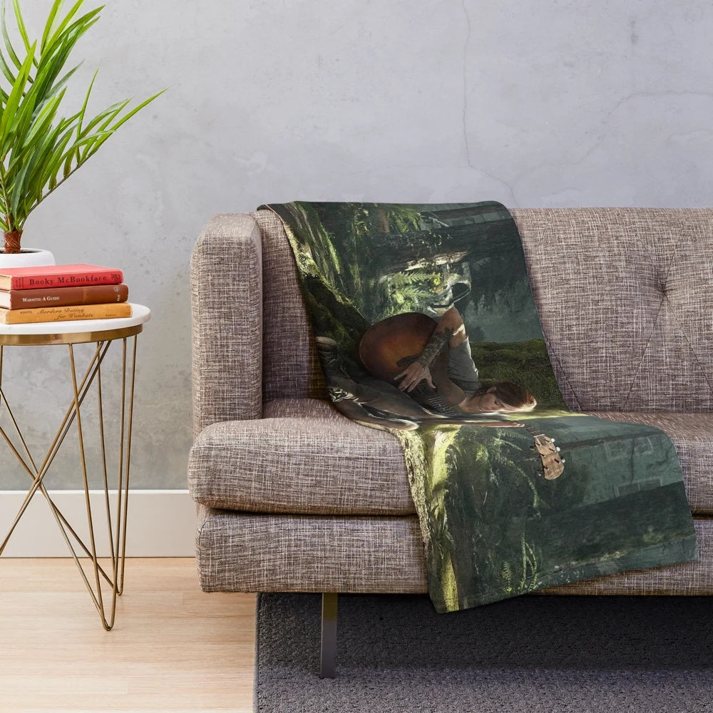 Ellie from The Last of Us playing guitar on a plush blanket