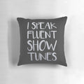 A plush pillow featuring the text "I Speak Fluent Showtunes" against a theatre-inspired background.