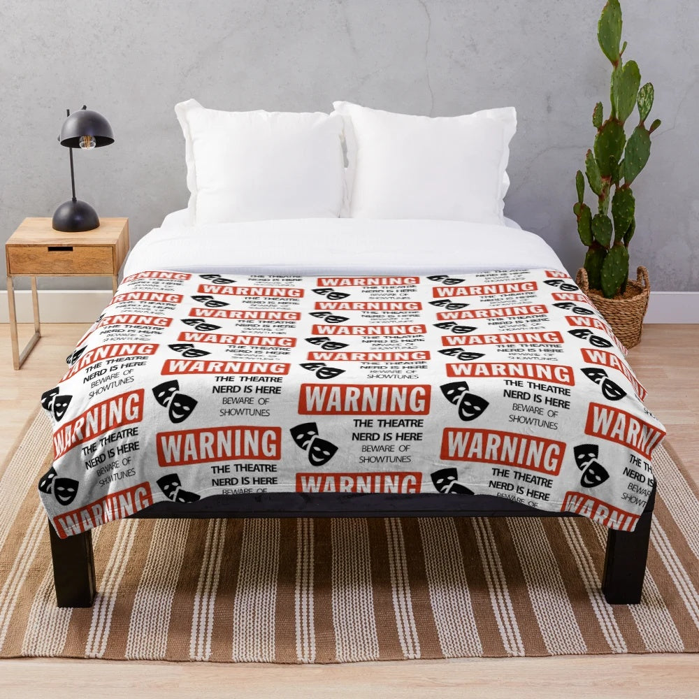 Plush theatre nerd blanket featuring show-themed designs for musical lovers