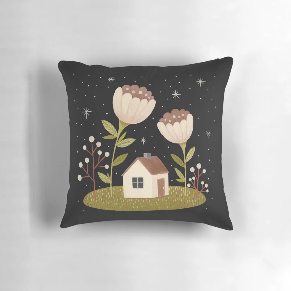 Throw pillow featuring a cozy tiny house surrounded by flowers under a starry night sky