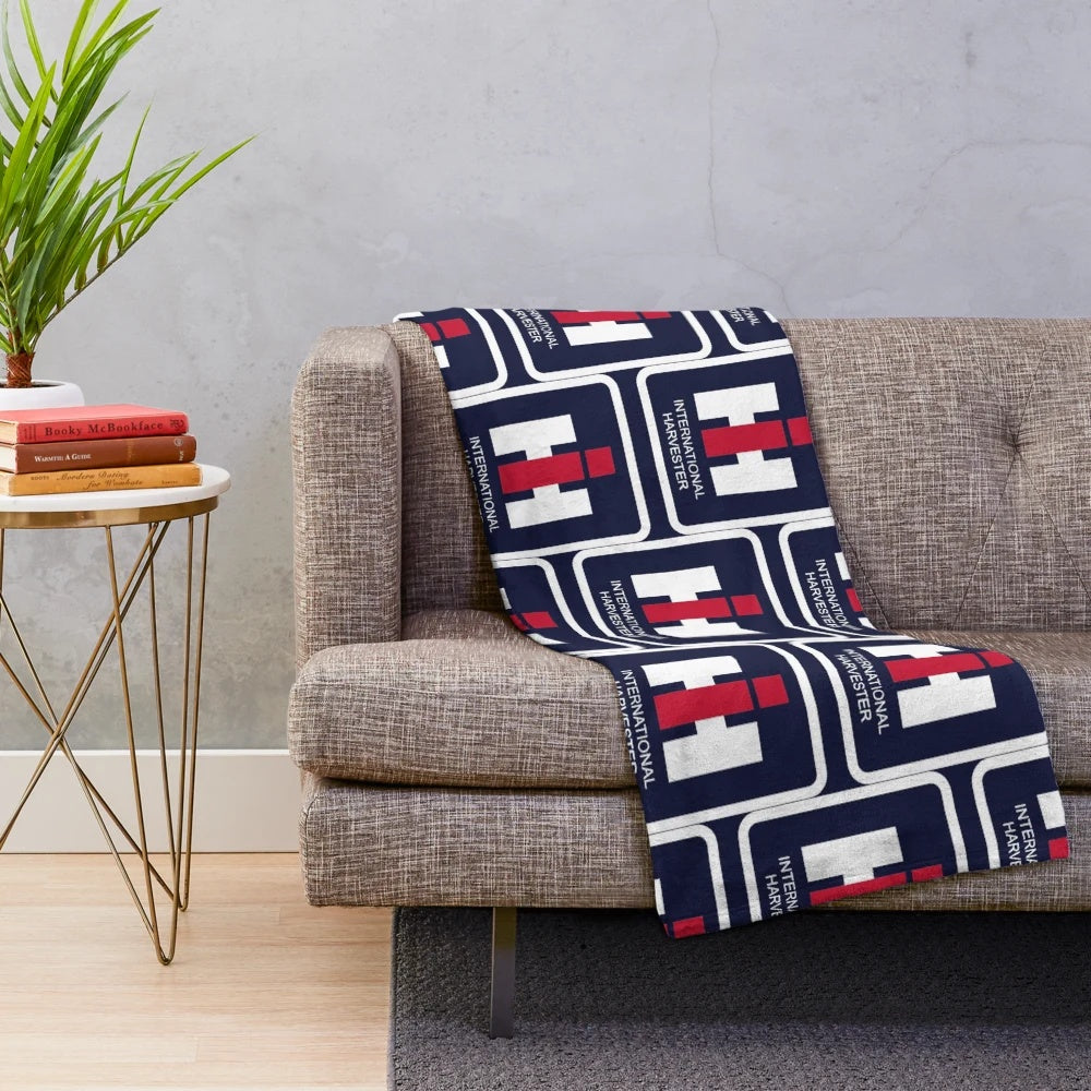 Tractor-inspired plush blanket with farm equipment logos