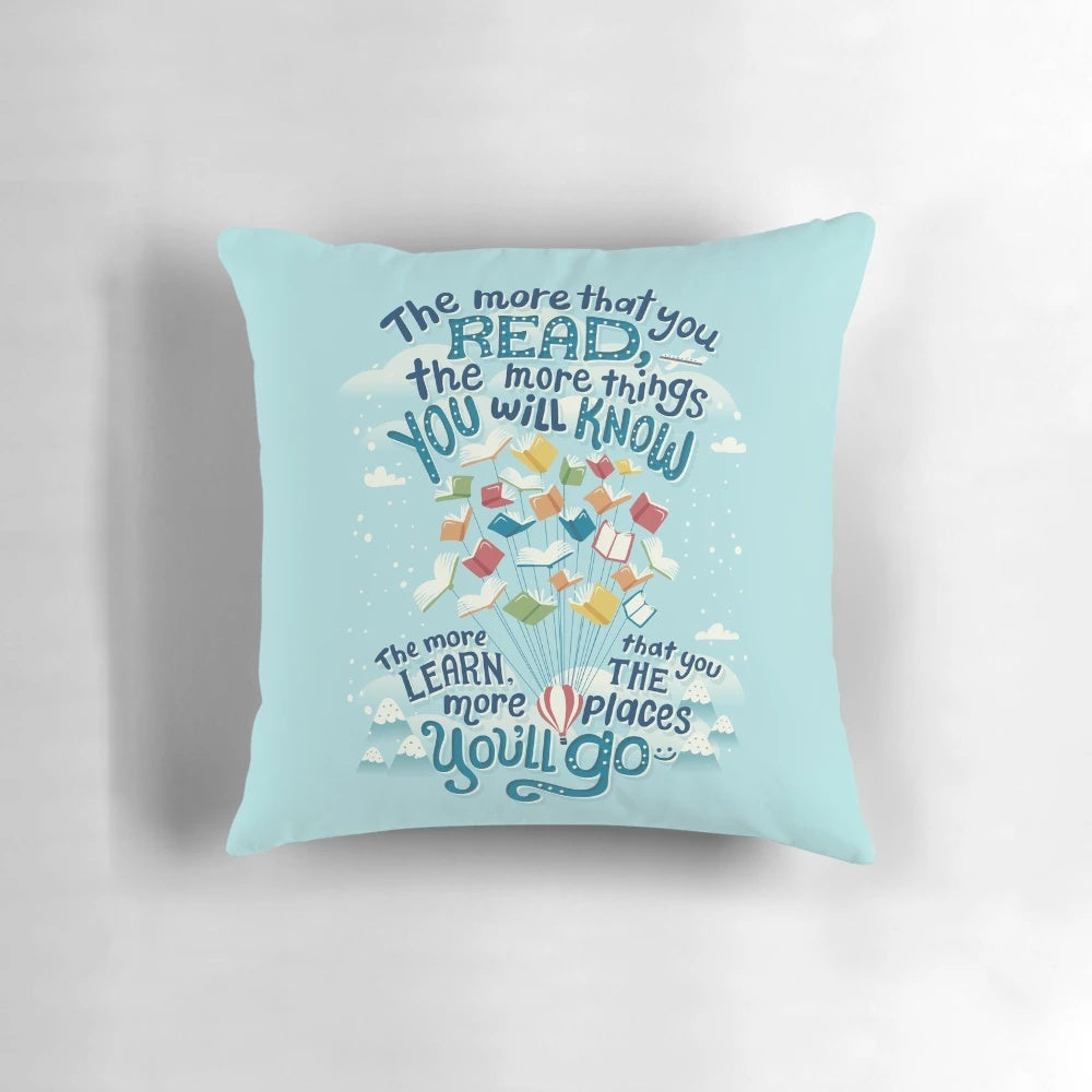 A soft, decorative pillow featuring a whimsical design with hot air balloons, perfect for readers and book enthusiasts.