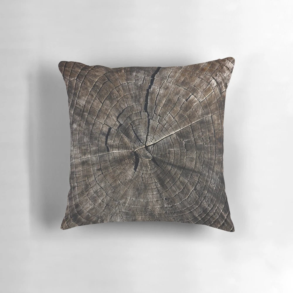 Close-up image of a pillow with a tree rings pattern, showcasing the natural beauty of wood