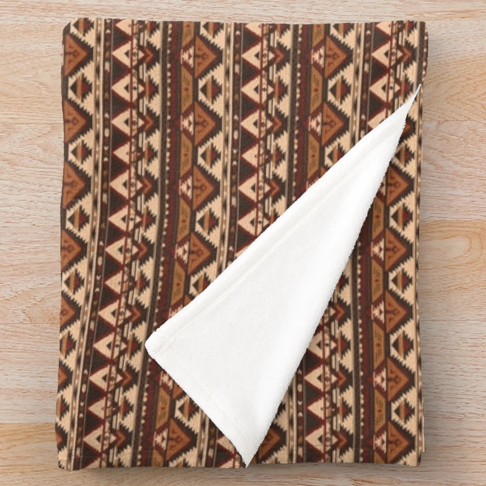 Plush blanket featuring a geometric pattern of indigenous trees