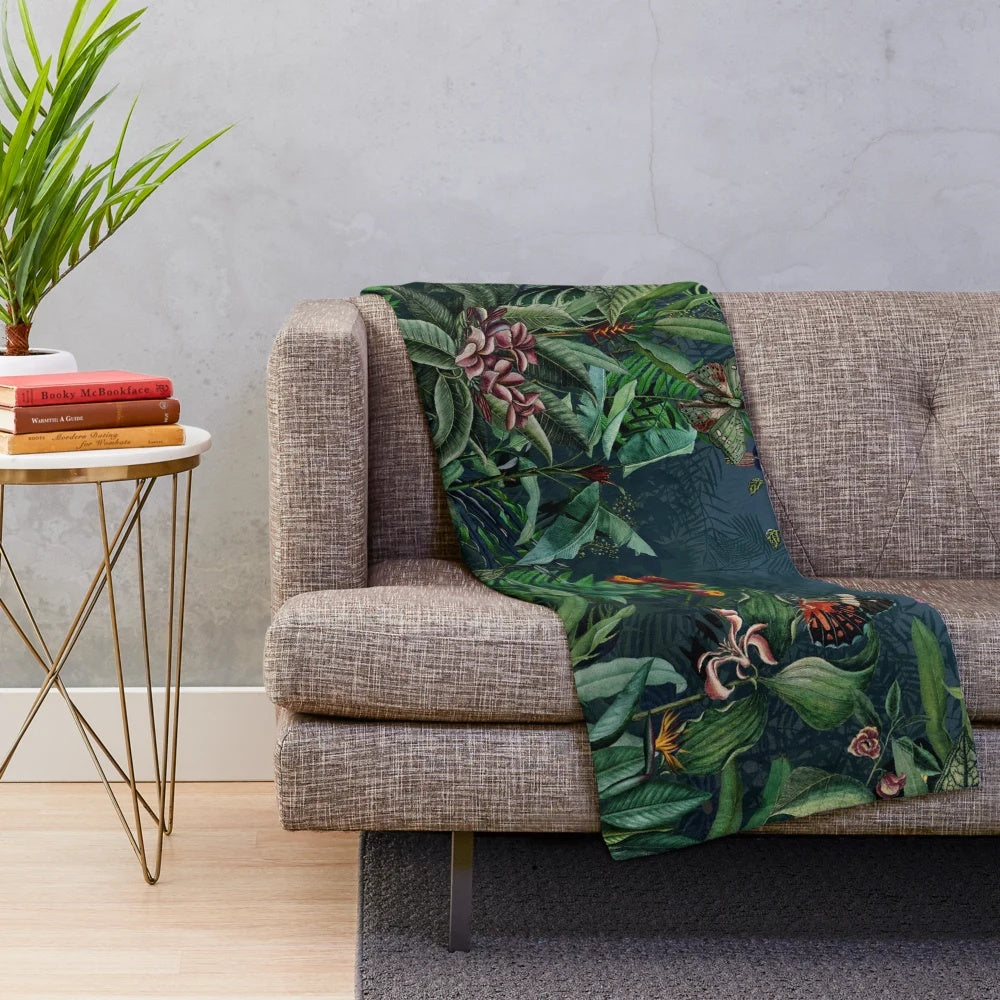 Lush tropical foliage and botanical elements on a plush blanket
