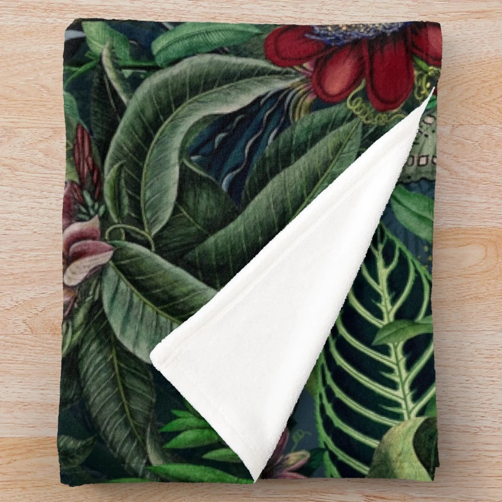 Lush tropical foliage and botanical elements on a plush blanket