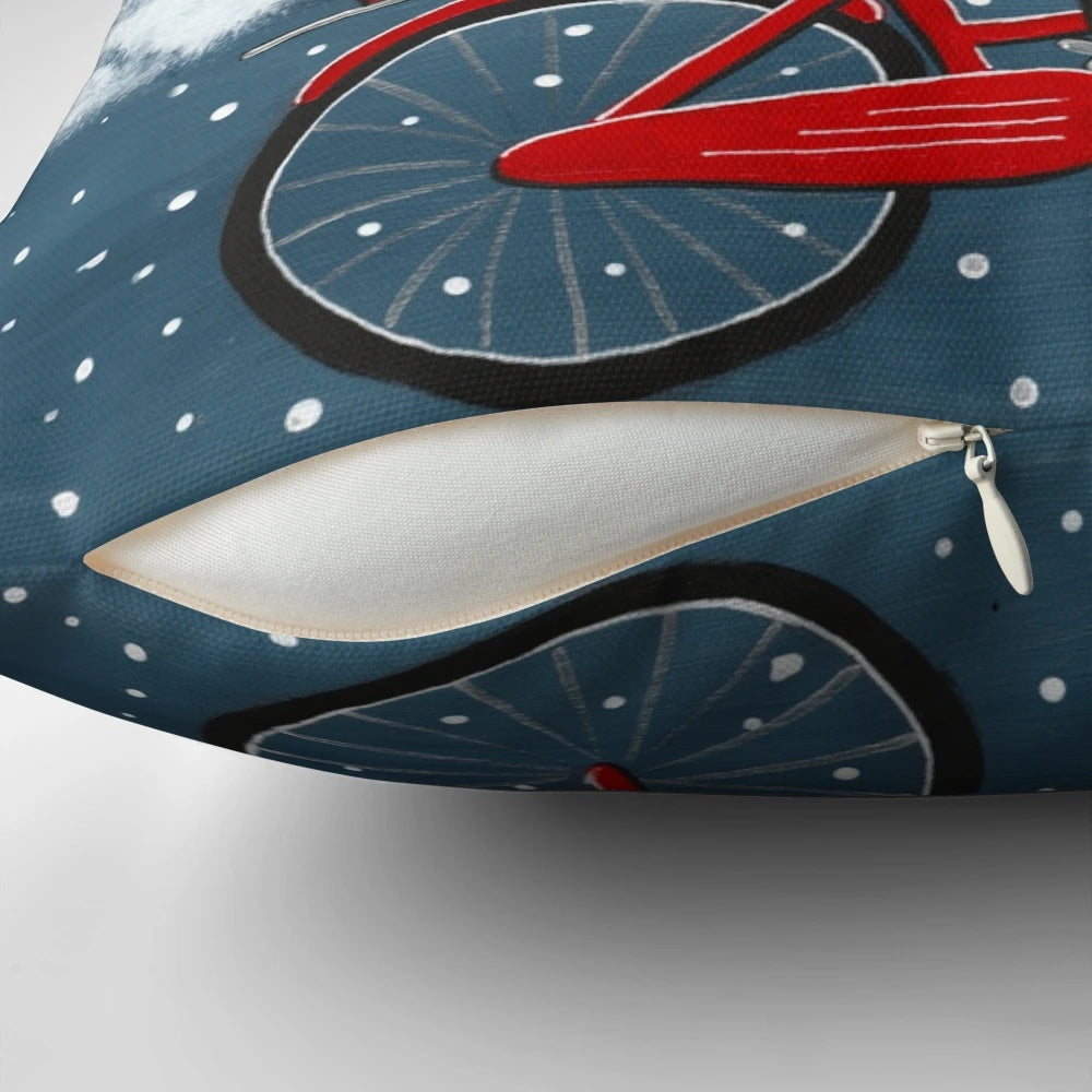 Whimsical tuxedo cat riding a bicycle through a snowy winter scene, printed on a decorative throw pillow.