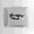 Soft, plush pillow featuring a sleeping tuxedo cat in a comfortable lounging pose