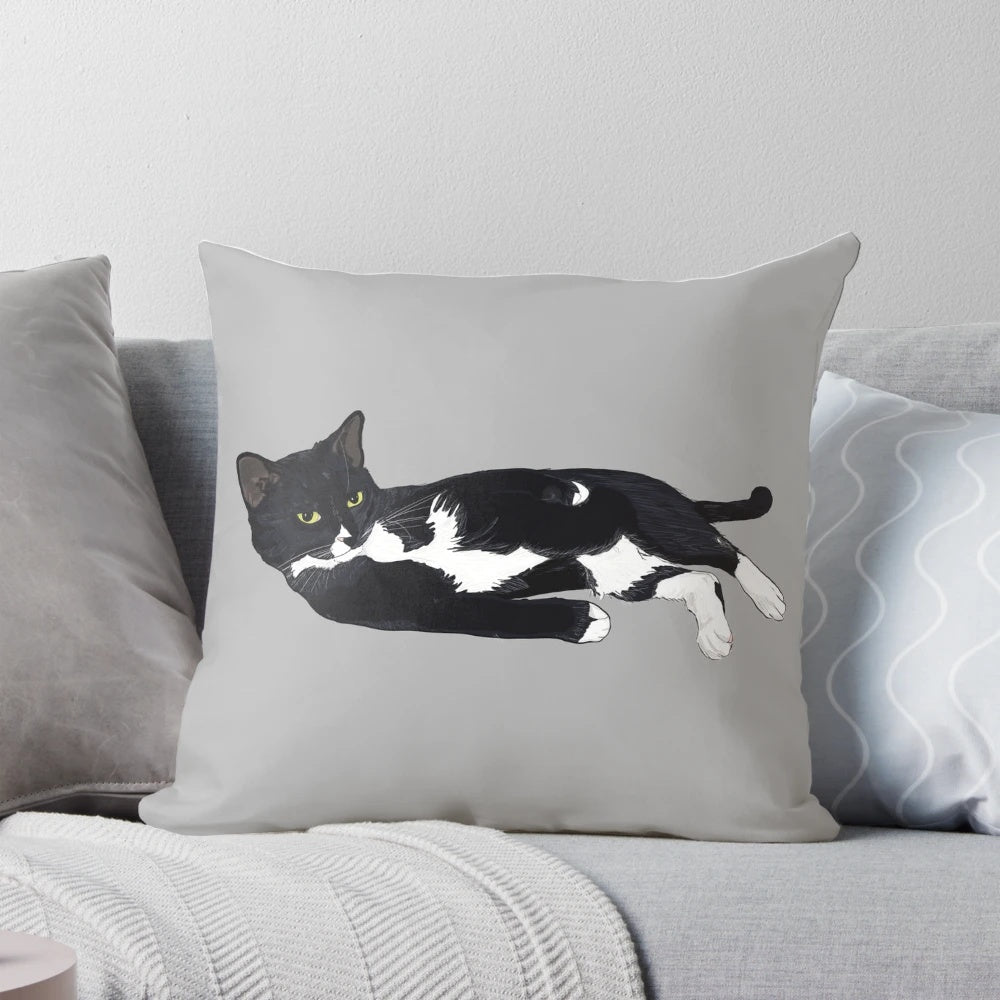 Soft, plush pillow featuring a sleeping tuxedo cat in a comfortable lounging pose